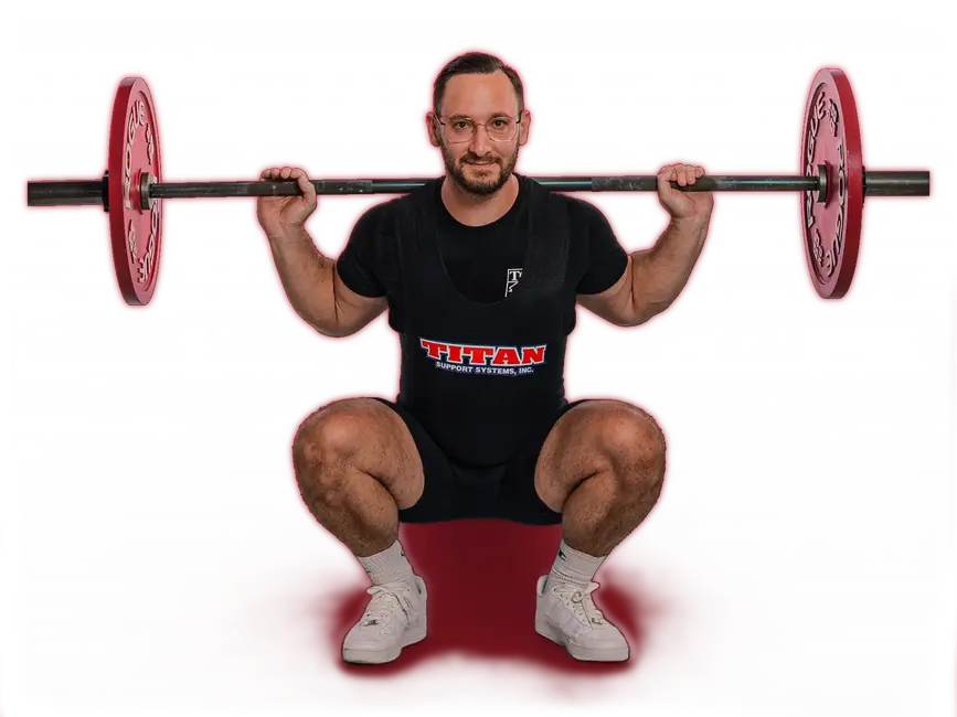 Ein Mann der Turngemeinde hebt eine Langhantel in der Hocke, gekleidet in Sportkleidung des TGL Vereins.